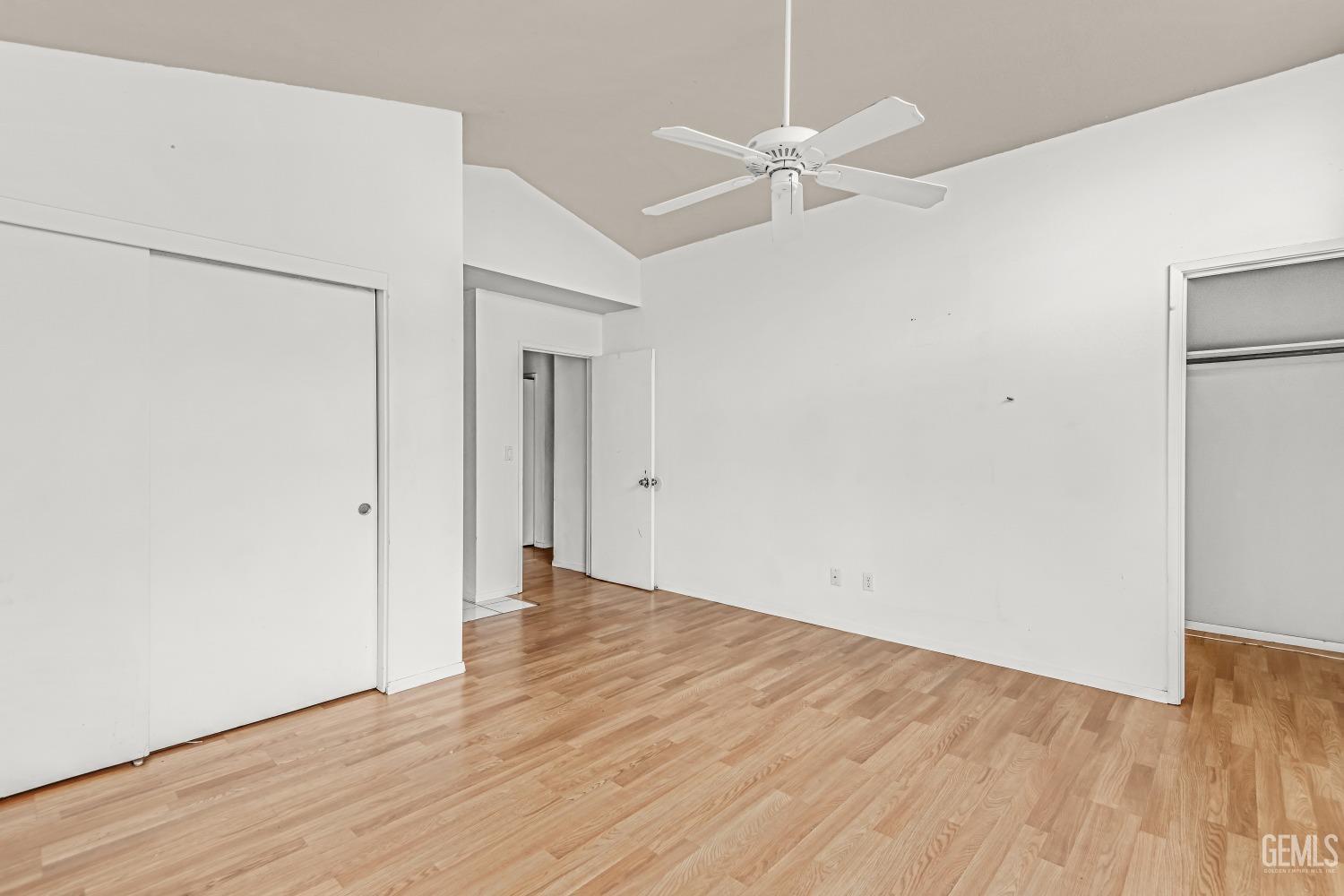 Undisclosed Address Bakersfield, CA 93313 - Photo 22 of 34 an empty room with wooden floor fan and windows