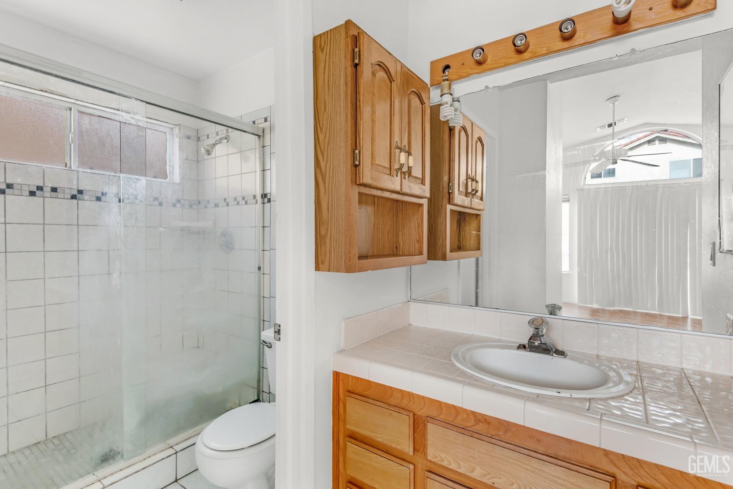 Undisclosed Address Bakersfield, CA 93313 - Photo 23 of 34 a bathroom with a sink a toilet and shower