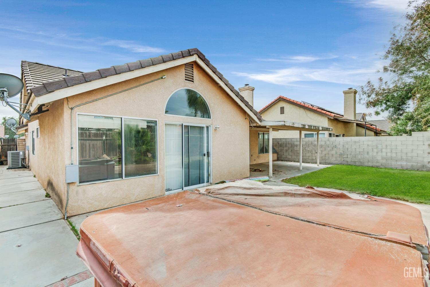 Undisclosed Address Bakersfield, CA 93313 - Photo 27 of 34 a front view of a house with a yard and garage