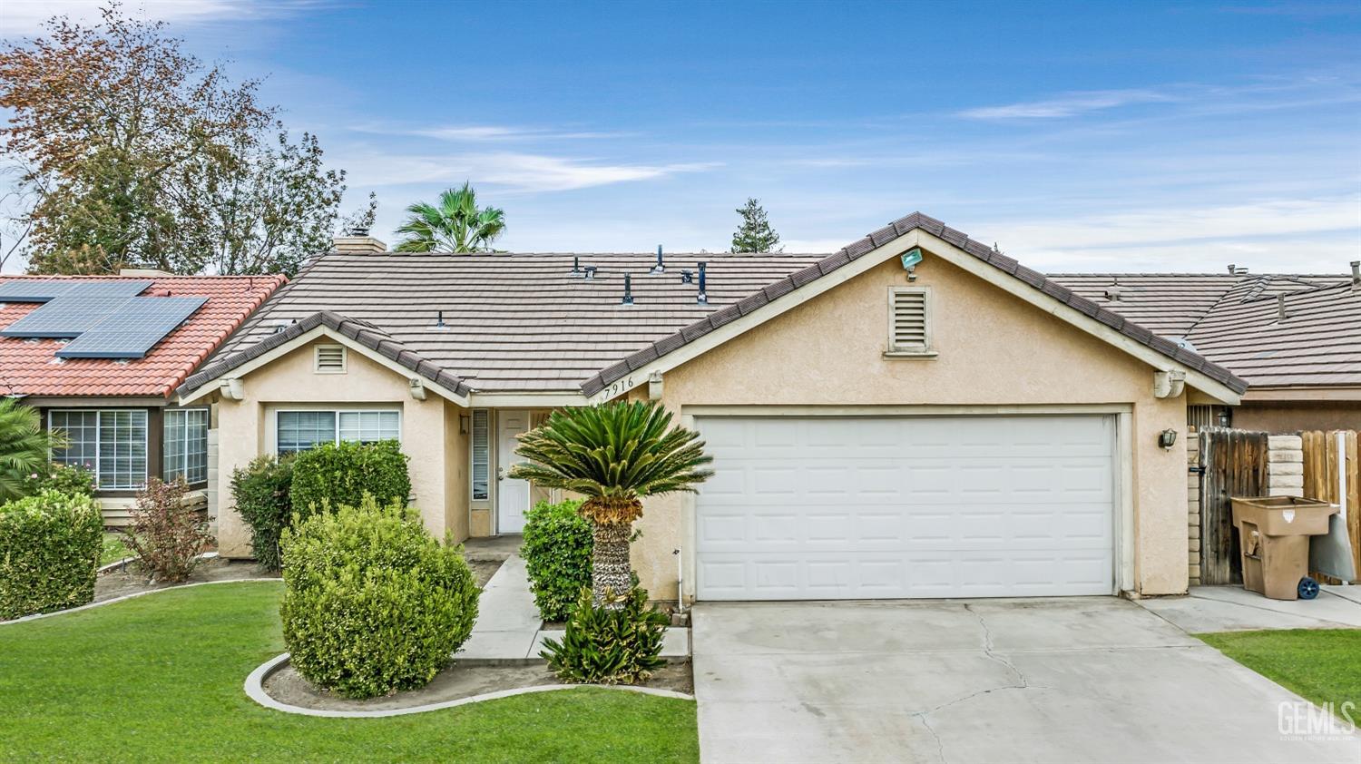 Undisclosed Address Bakersfield, CA 93313 - Photo 30 of 34 a front view of a house with a yard and potted plants