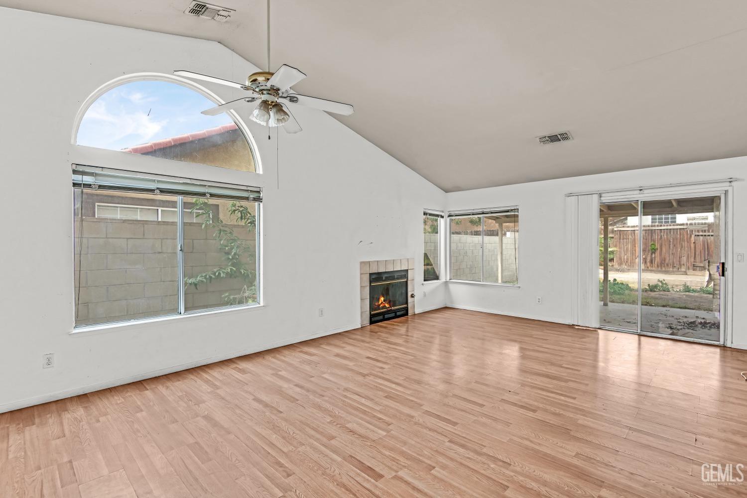 Undisclosed Address Bakersfield, CA 93313 - Photo 6 of 34 an empty room with wooden floor chandelier and windows