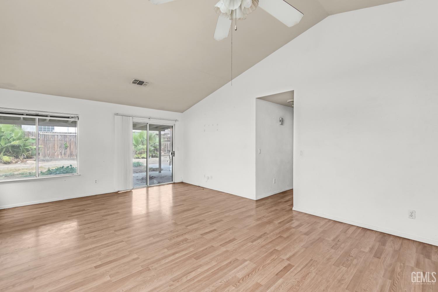 Undisclosed Address Bakersfield, CA 93313 - Photo 8 of 34 an empty room with wooden floor and windows