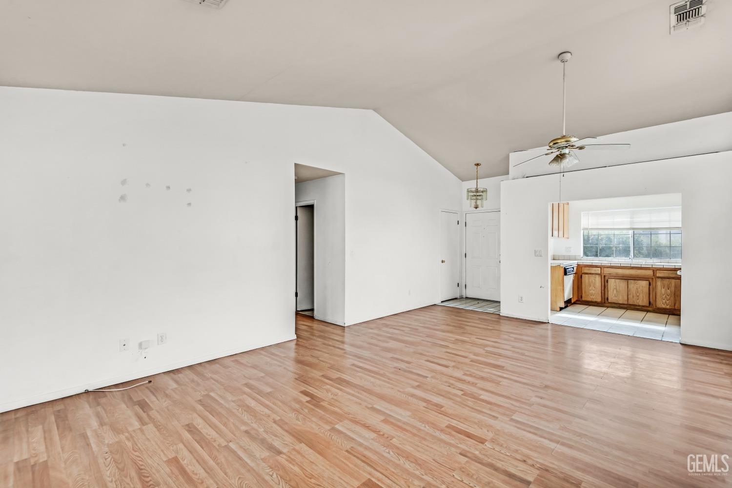 Undisclosed Address Bakersfield, CA 93313 - Photo 9 of 34 a view of an empty room with wooden floor and a window