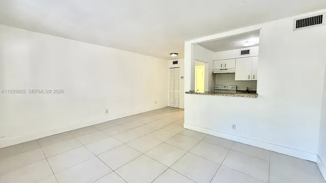 a view of a sink and a microwave in a white cabinet