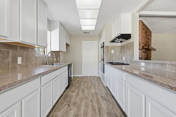 a kitchen with a sink cabinets and appliances