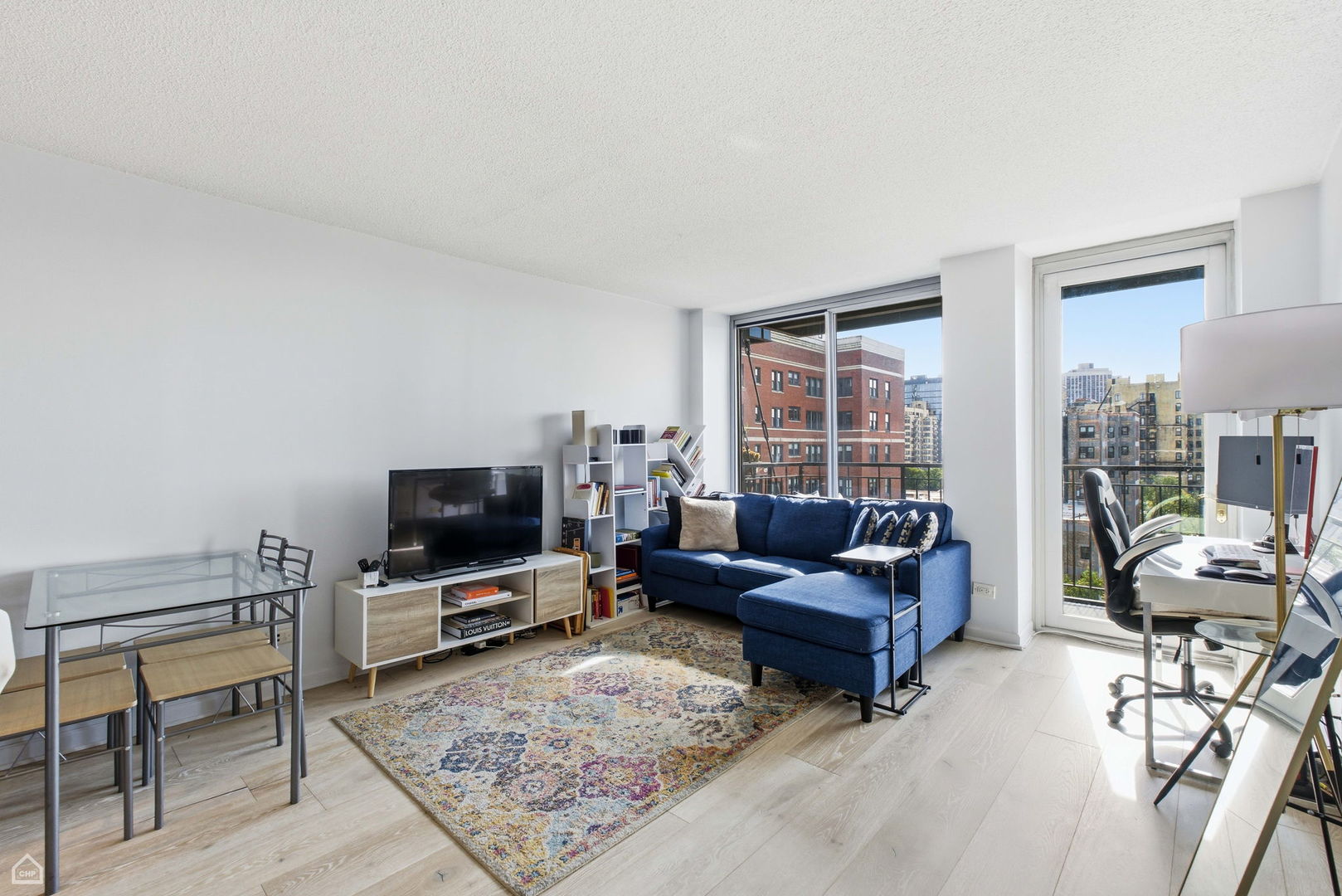 450 West Briar Place, Unit 10H Chicago, IL 60657 - Photo 5 of 17 a living room with furniture and a flat screen tv