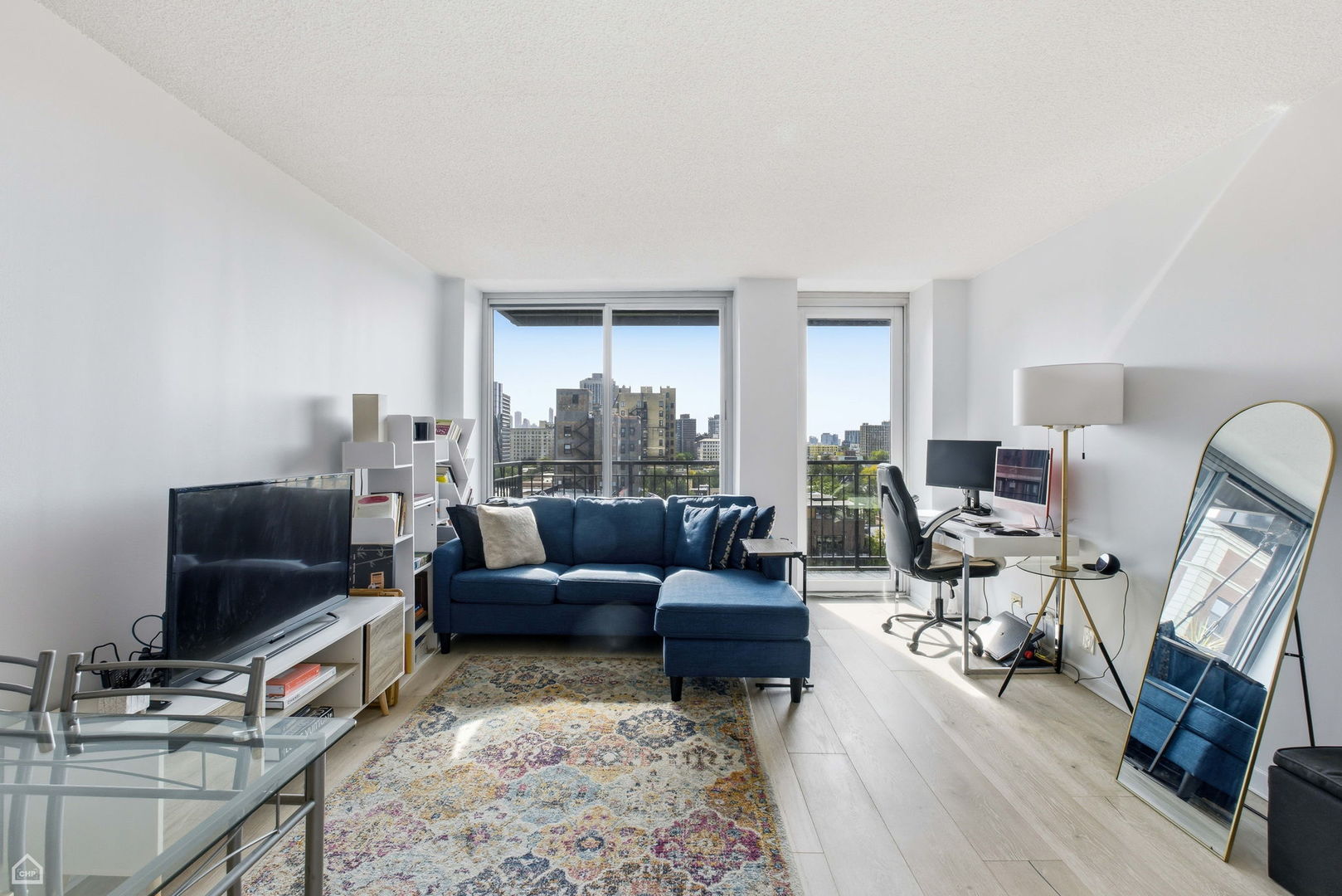 450 West Briar Place, Unit 10H Chicago, IL 60657 - Photo 6 of 17 a living room with furniture and a flat screen tv