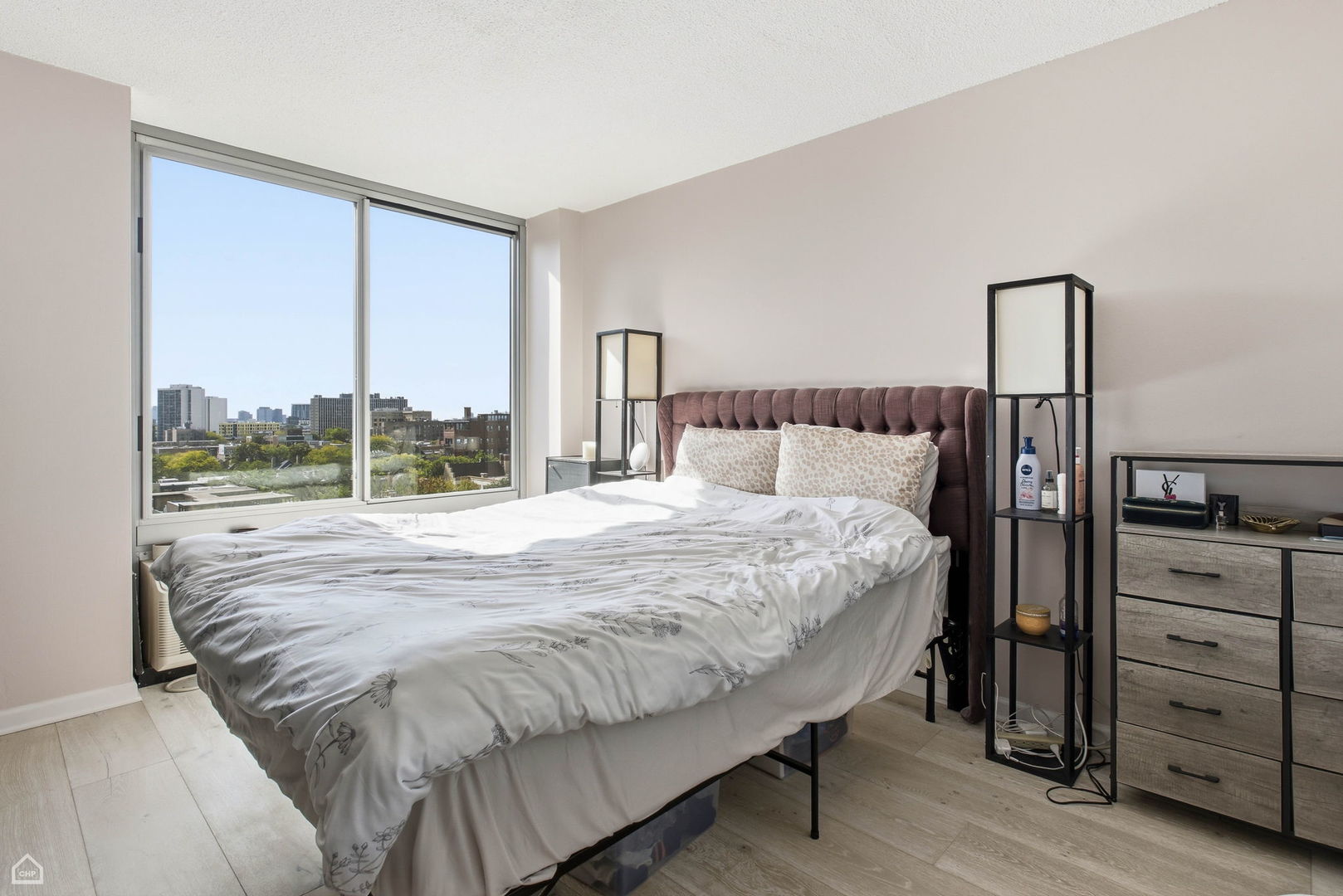 450 West Briar Place, Unit 10H Chicago, IL 60657 - Photo 9 of 17 a large bed sitting in a bedroom next to a window