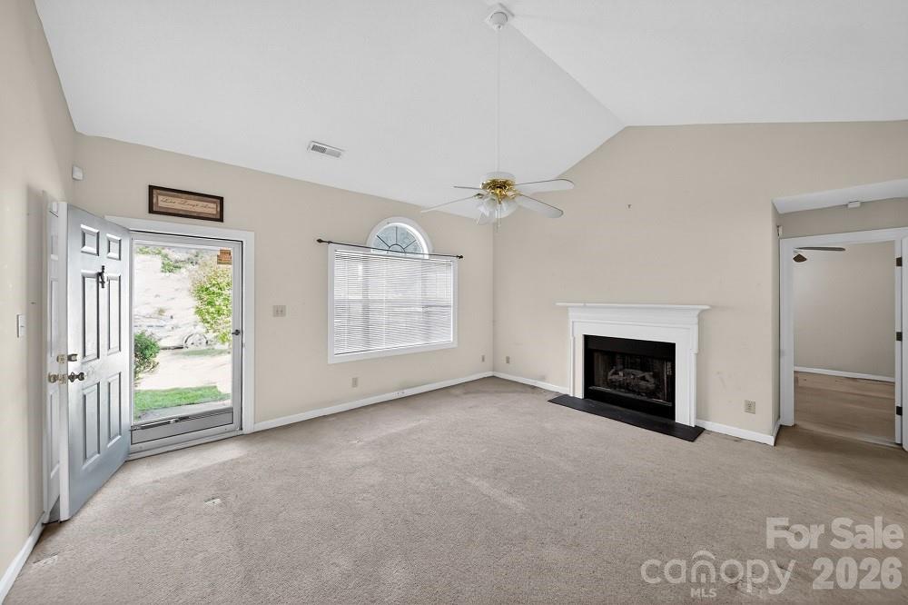 2205 Old Sparta Road Rocky Mount, NC 27804 - Photo 11 of 25 an empty room with furniture and a fireplace