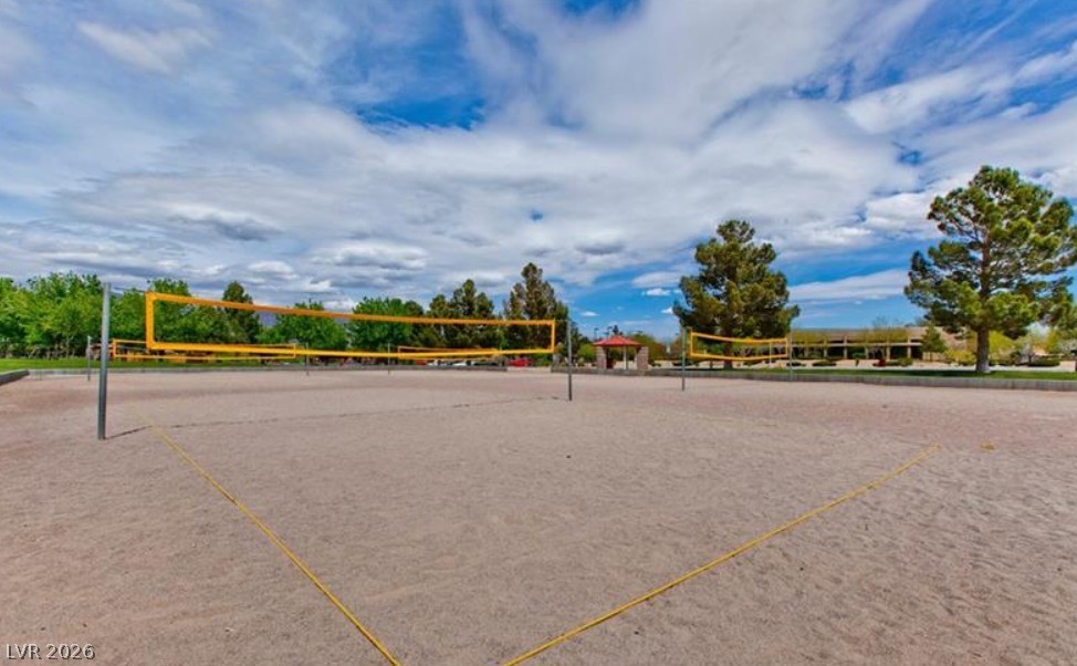 6405 North Raptor Court North Las Vegas, NV 89084 - Photo 58 of 66 Sand volleyball courts invite outdoor recreation under a vast, cloud-dappled sky.