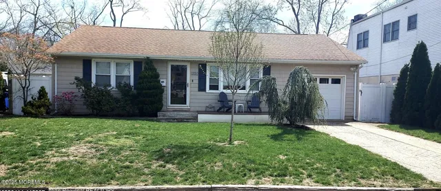 a view of a house with brick walls and a yard with plants