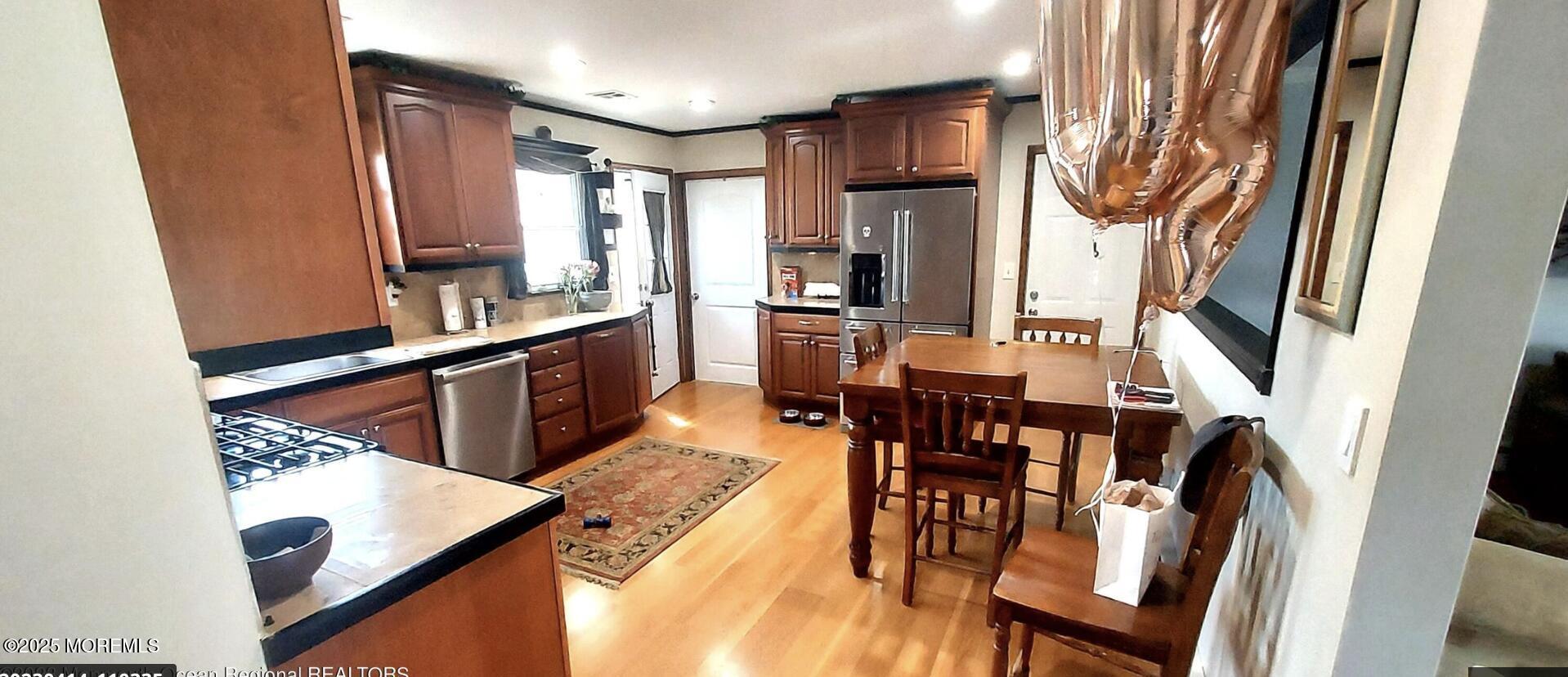 1220 Sunset Avenue Point Pleasant, NJ 08742 - Photo 4 of 10 a kitchen with stainless steel appliances kitchen island granite countertop a refrigerator a stove a sink and dishwasher