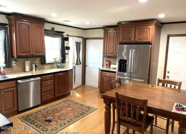 a kitchen with stainless steel appliances granite countertop a stove refrigerator sink and cabinets