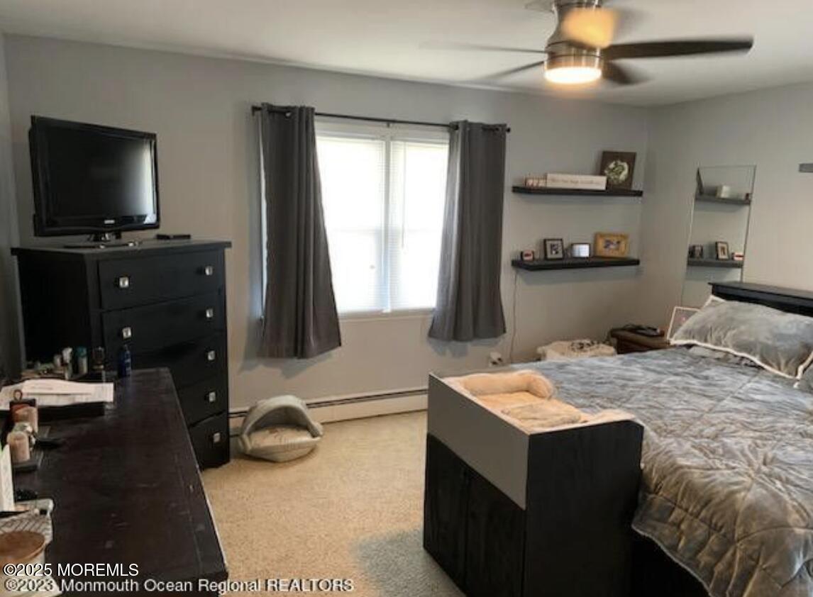 1220 Sunset Avenue Point Pleasant, NJ 08742 - Photo 6 of 10 a room with a bed and a flat screen tv