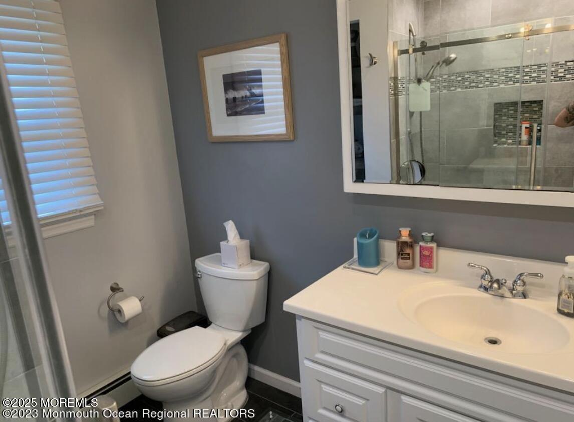 1220 Sunset Avenue Point Pleasant, NJ 08742 - Photo 8 of 10 a bathroom with a sink a toilet and shower