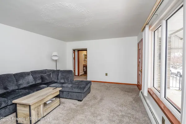 a living room with furniture and a large window