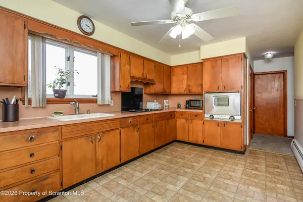 a large kitchen with stainless steel appliances granite countertop a large stove a sink dishwasher and a refrigerator with wooden floor