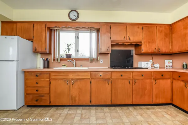 a kitchen with stainless steel appliances granite countertop a sink a stove and a refrigerator