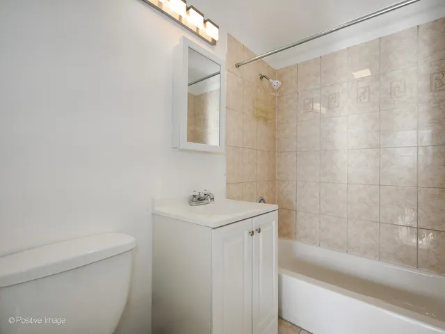 a bedroom with a bed lamp and window