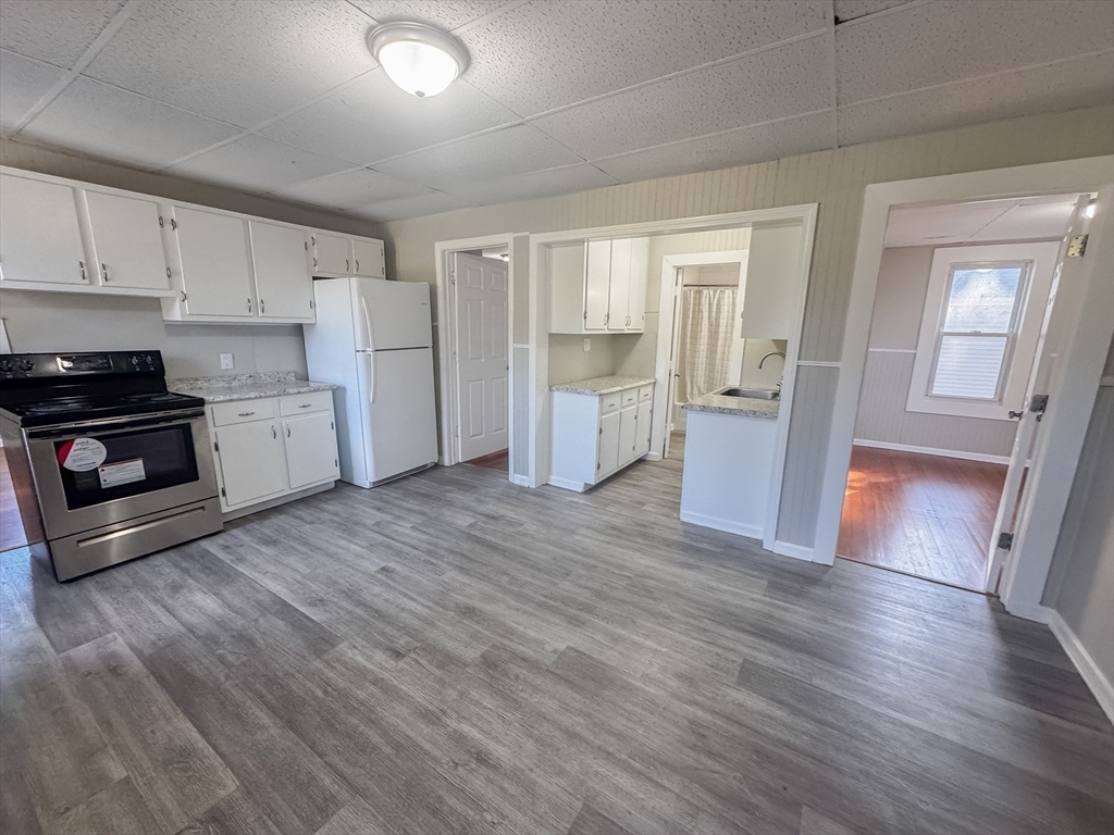 3-5 Noel Street Springfield, MA 01108 - Photo 12 of 28 a view of a kitchen with wooden floor and electronic appliances