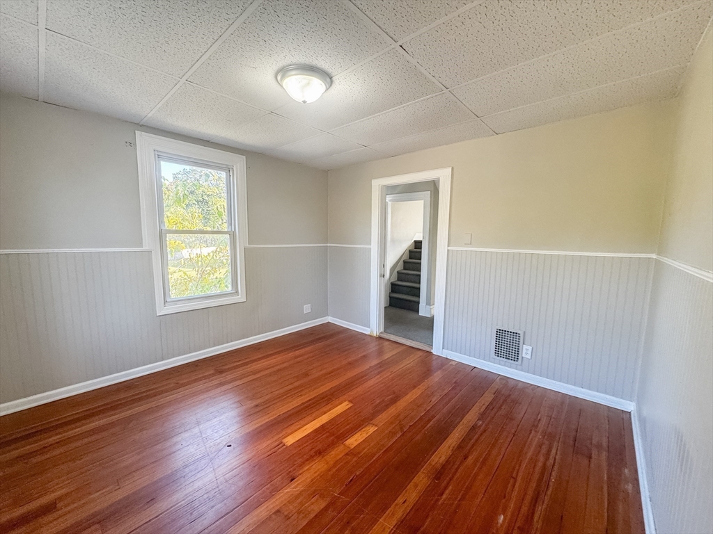 3-5 Noel Street Springfield, MA 01108 - Photo 15 of 28 an empty room with wooden floor and windows