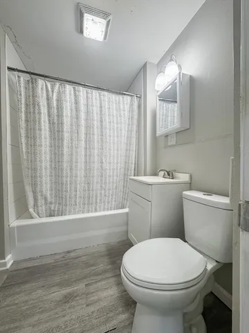 a bathroom with a toilet a sink and a mirror