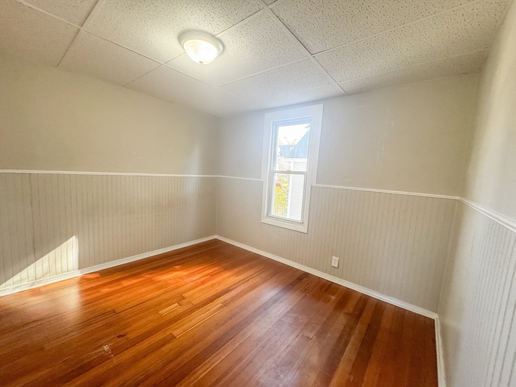 3-5 Noel Street Springfield, MA 01108 - Photo 20 of 28 an empty room with wooden floor and windows