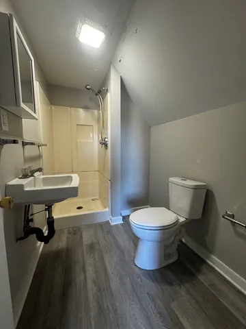 a bathroom with a sink toilet and a mirror
