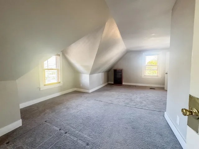 an empty room with windows and entrance