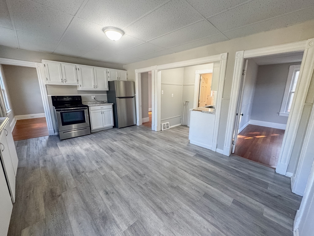 3-5 Noel Street Springfield, MA 01108 - Photo 5 of 28 a view of a kitchen with wooden floor and electronic appliances