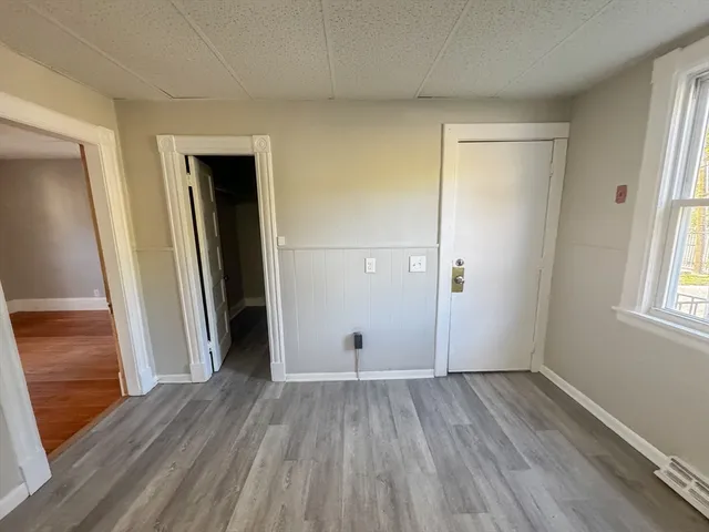wooden floor in an empty room with a window