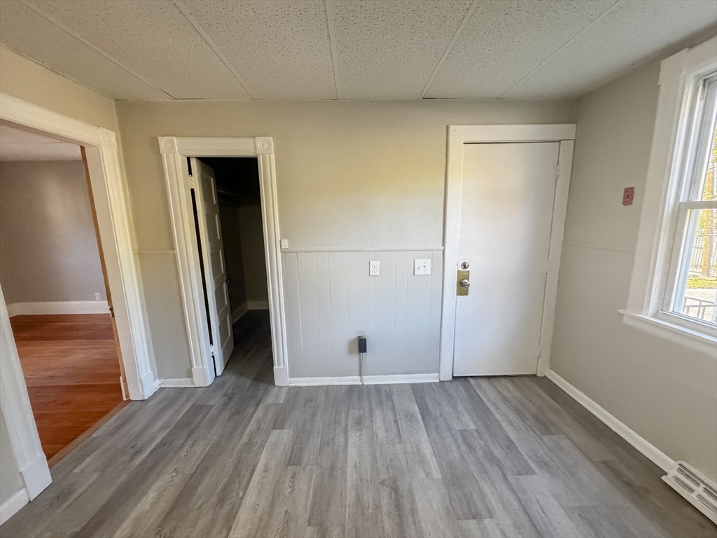 3-5 Noel Street Springfield, MA 01108 - Photo 7 of 28 wooden floor in an empty room with a window
