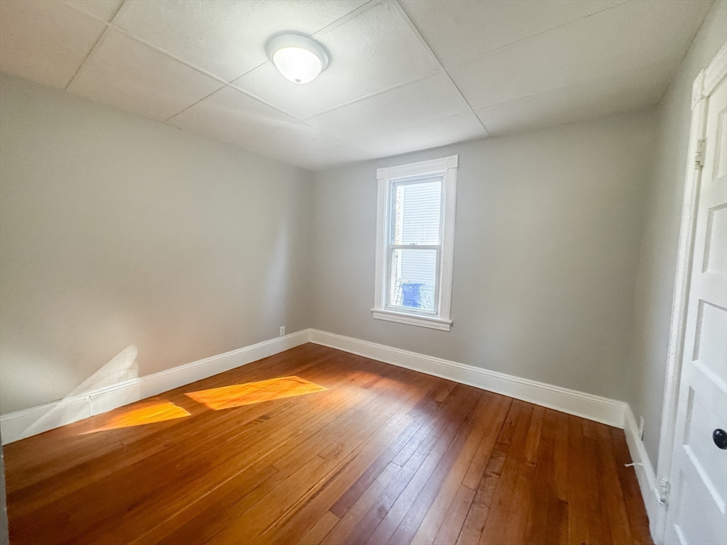 3-5 Noel Street Springfield, MA 01108 - Photo 10 of 28 an empty room with wooden floor and windows