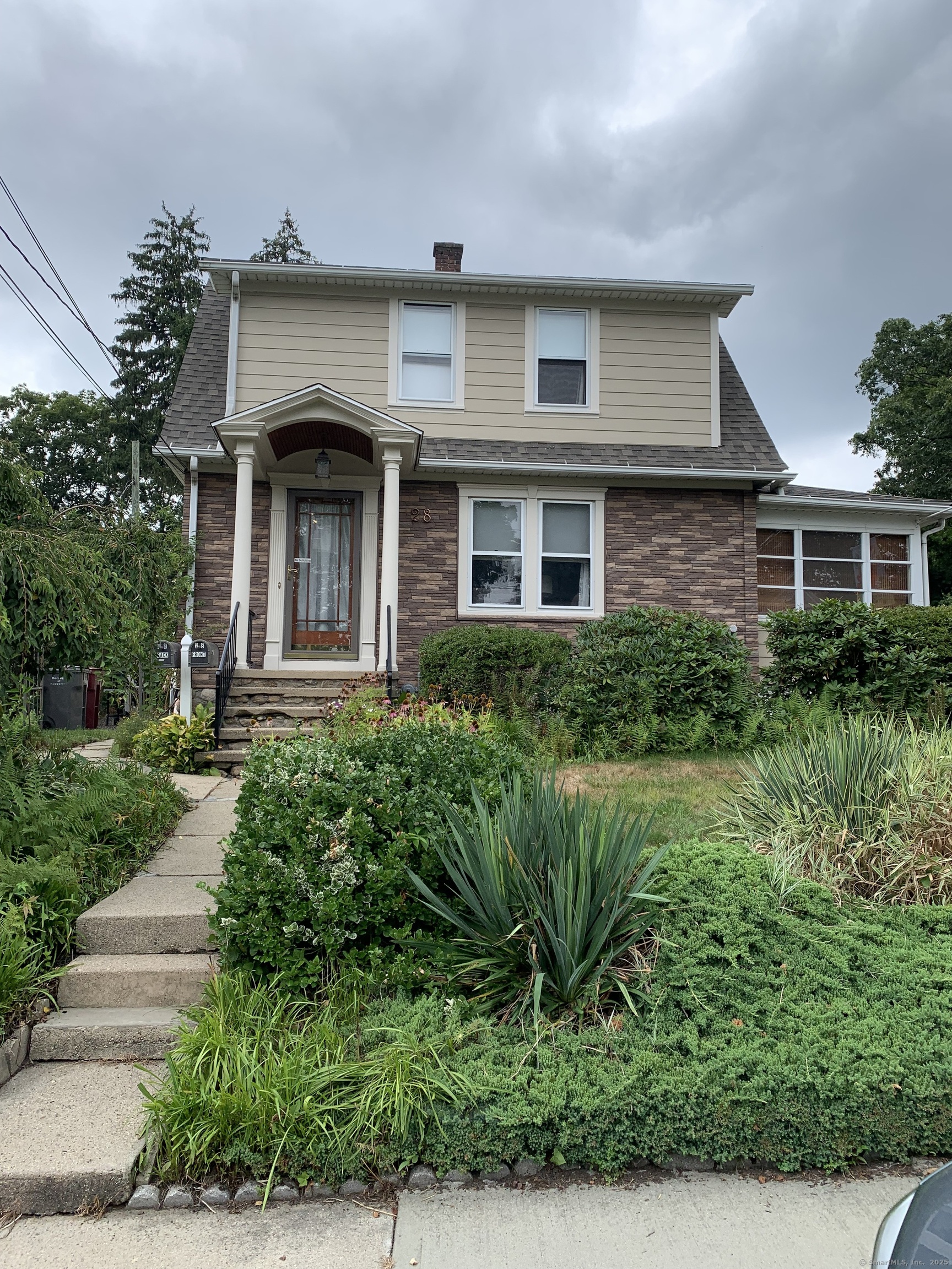 28 Galpin Street Naugatuck, CT 06770 - Photo 2 of 16 a front view of a house with a yard