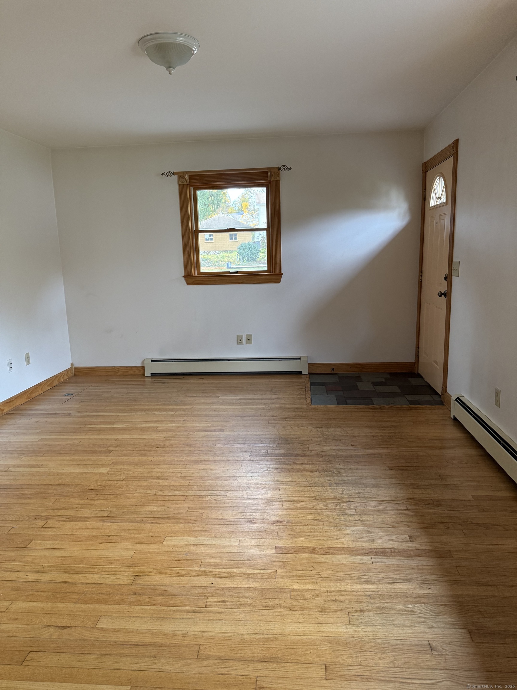 28 Galpin Street Naugatuck, CT 06770 - Photo 7 of 16 an empty room with wooden floor and windows