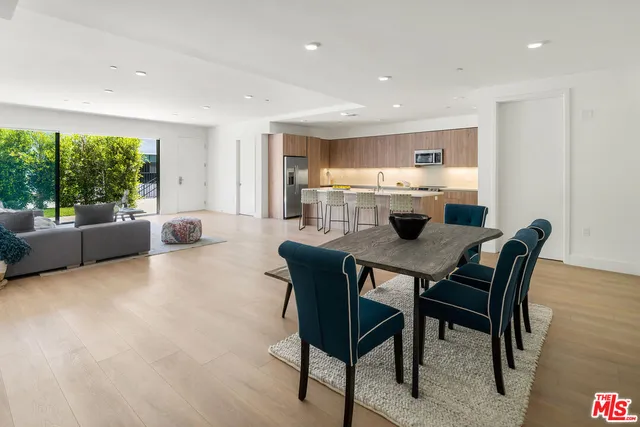 a view of a dining room with furniture and a large window
