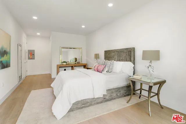 a bedroom with a bed and a lamp