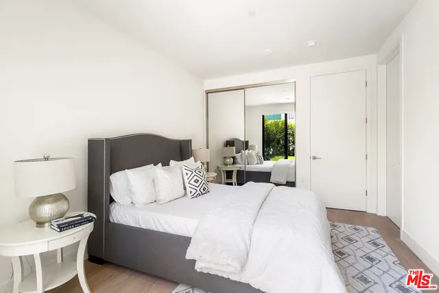 a bedroom with a bed and a chair