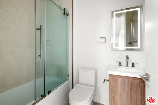 a bathroom with a toilet a sink and shower