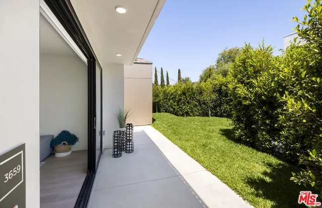 a view of a porch with couches and wooden floor