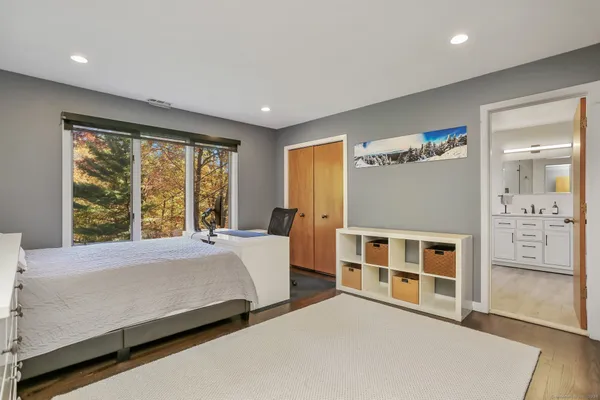 a bedroom with a large bed and a window