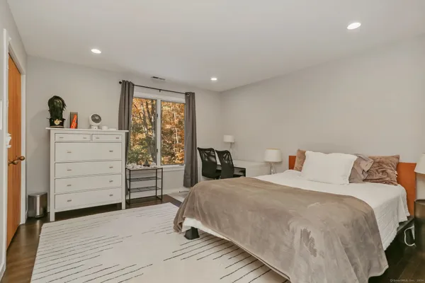 a bedroom with a bed and a window