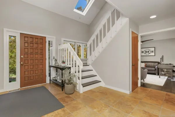 a view of front door with hallway and stairs