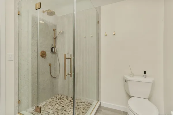 a bathroom with a toilet and shower