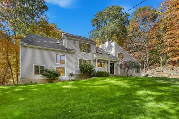 a front view of house with a garden and patio