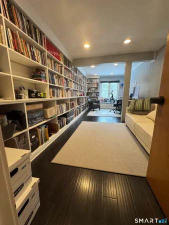 a living room with furniture and a book shelf