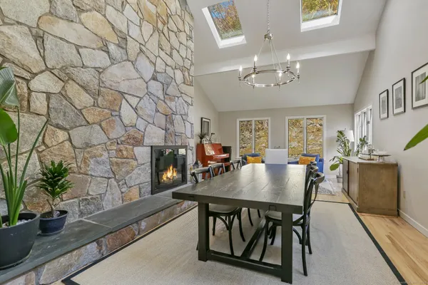 a view of a dining room with furniture and chandelier