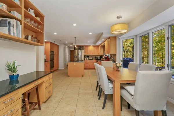 a large kitchen with a table and chairs