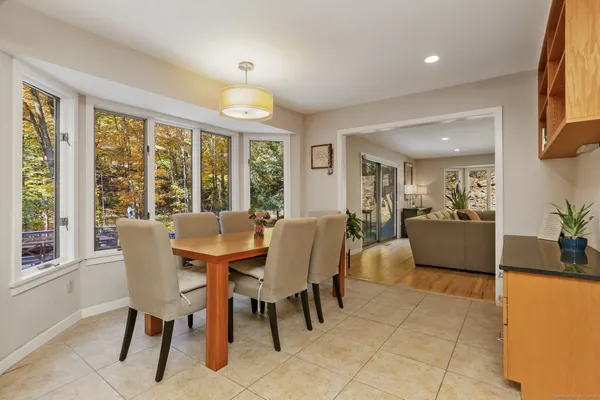 a dining room with furniture and large windows