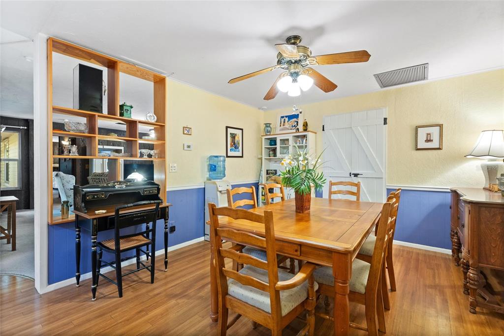 3641 Turtle Mound Road Melbourne, FL 32934 - Photo 12 of 77 a view of a dining room with furniture and wooden floor